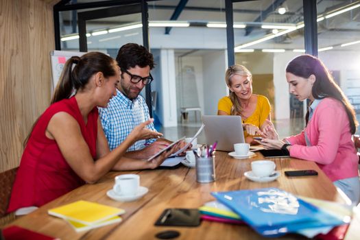 Casual business team using technology in the office