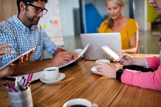 Casual business team using technology in the office