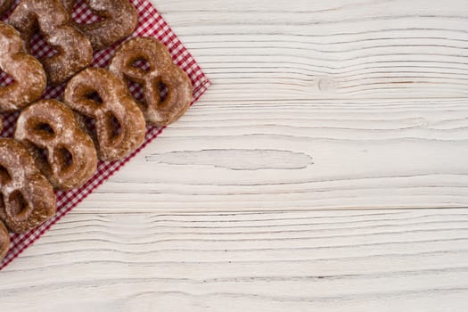 Gingerbread heart cookies on a wooden white background. Top view.