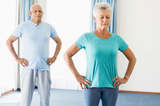 Seniors performing yoga in a studio