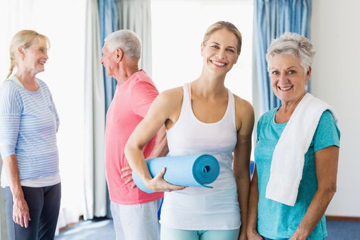 Instructor standing together with seniors during sports class