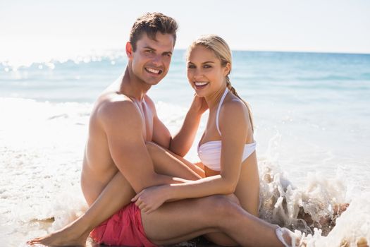 Portrait of romantic young couple having fun on beach