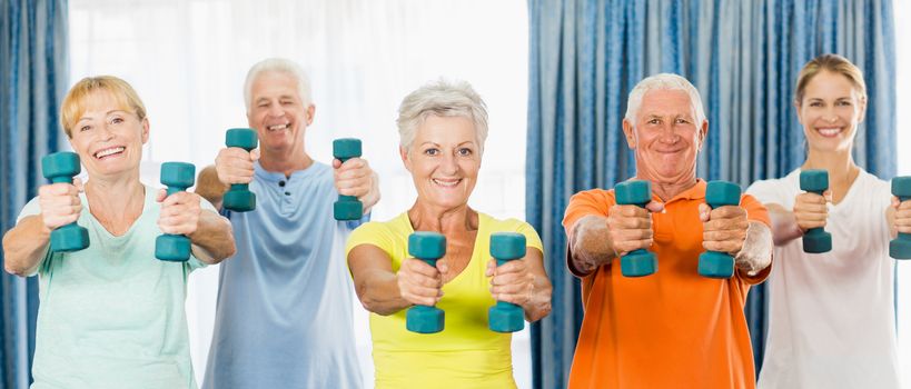 Seniors exercising with weights during sports class