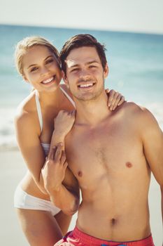 Portrait of romantic young couple having fun on beach