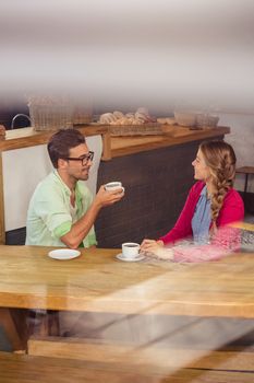 Couple interacting while drinking a coffee in the restaurant