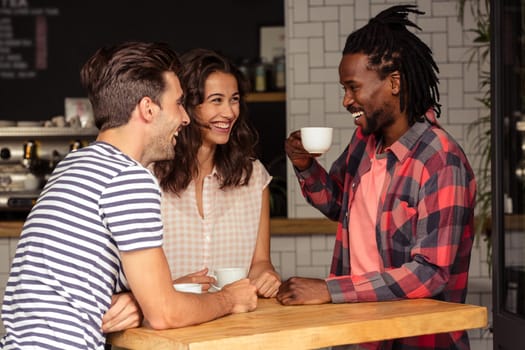 Friends talking together and smiling in cafeteria