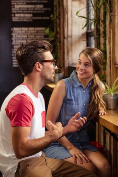 Smiling couple talking in cafeteria