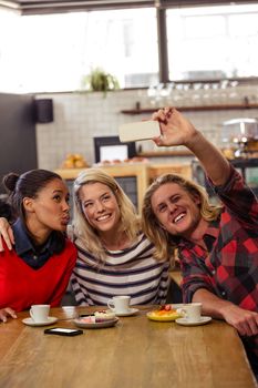 Friends taking a selfie in the cafe