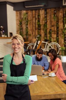 Waitress standing with arms crossed in a cafe