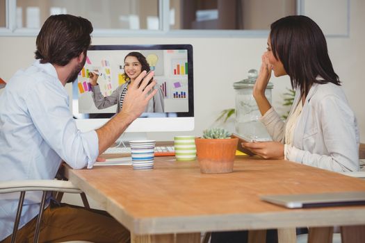 Business people having a video conference in office