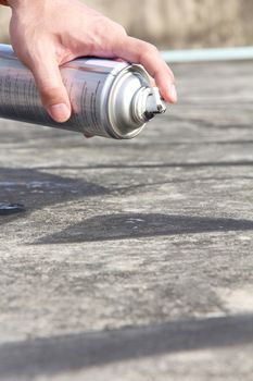 Hand holding graffiti spray