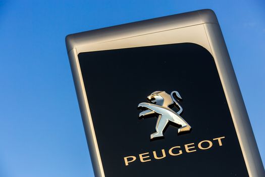 La rochelle, France - August 30, 2016: Official dealership sign of Peugeot against the blue sky. Peugeot is one of the most french automotive manufacturer