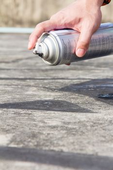 Hand holding graffiti spray