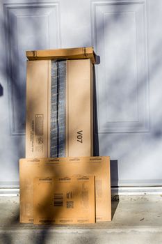 Paris, France - February 08, 2017: Amazon Prime Parcel Package in front the door of a house. Amazon, is an American electronic commerce and cloud computing company,based in Seattle, Started as an online bookstore, Amazon is become the most importrant retailer in the United States