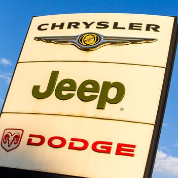 La rochelle, France - August 30, 2016: Official dealership sign of Chrysler, Jeep, and Dodge against the blue sky. American brand of cars, minivans, and sport utility vehicles manufactured by FCA US LLC