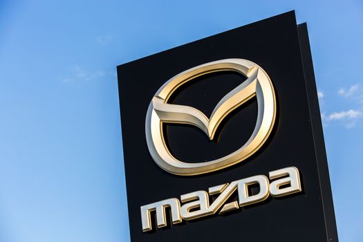 La rochelle, France - August 30, 2016: Official dealership sign of Mazda against the blue sky. Mazda Corporation is a Japanese automotive manufacturer