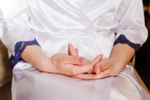 close-up bride hands with manicure in wedding morning.