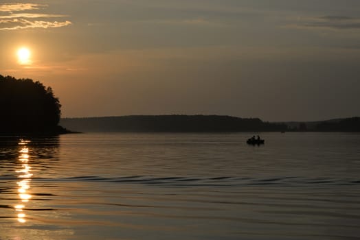 Fishermen returning late from a fishing trip in a rubber boat