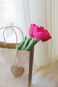 bouquet of red tulips in paper kraft bag