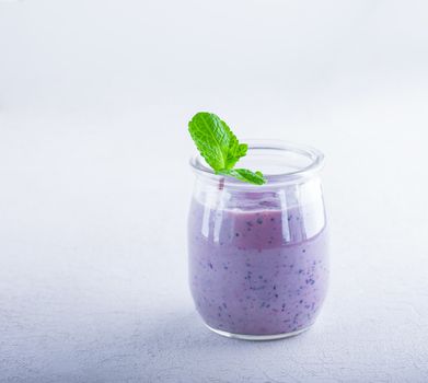 Delicious blueberry yoghurt smoothie in a glass.