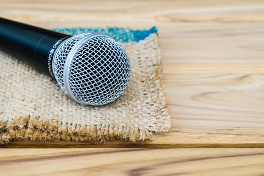 microphone on sack wooden background