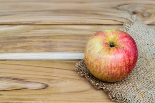 apple on sack wood background