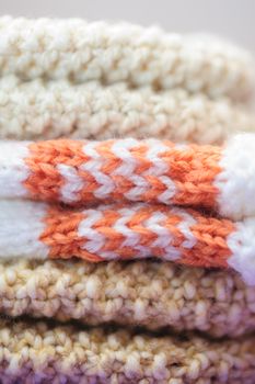 Knitted gloves stacked in the closet closeup