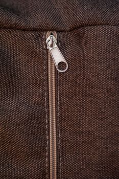 texture of brown fabric with zipper for background.