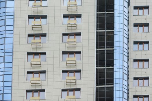 part of a modern multi-storey office building with balconies and windows.