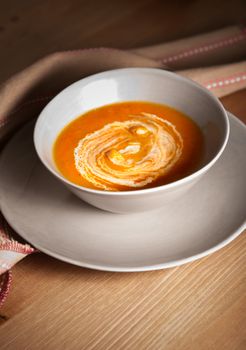 Pumpkin cream soup served on a wooden table