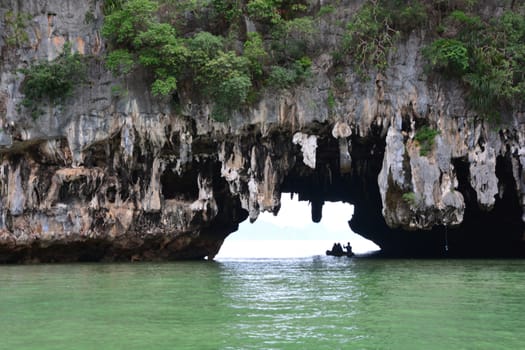 Tham Lod Yai (Grotto Cave) Jungle covered limestone cliffs at Phang Nga Bay