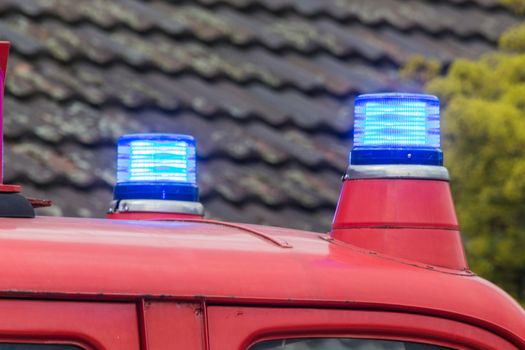 Two flashing blue lights on a fire truck.