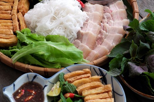 Delicious Vietnamese food, bun dau mam tom, is popular street food make from vermicelli with boiled meat, fried tofu, shrimp paste and green vegetables, cucumer and spice as chilli, lemon 