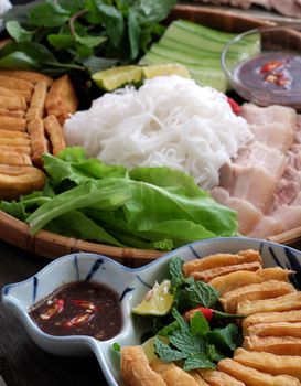 Delicious Vietnamese food, bun dau mam tom, is popular street food make from vermicelli with boiled meat, fried tofu, shrimp paste and green vegetables, cucumer and spice as chilli, lemon 