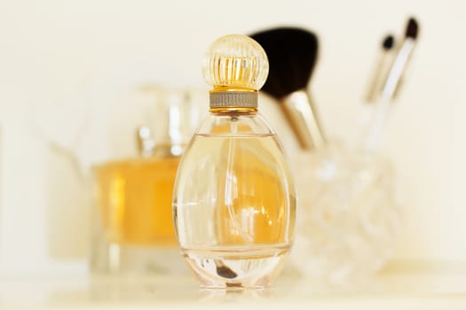 dressing table with women's accessories. perfume and makeup brushes on a  table, close-up