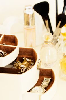 dressing table with women's accessories. perfume, jewelry and makeup brushes on a  table, close-up