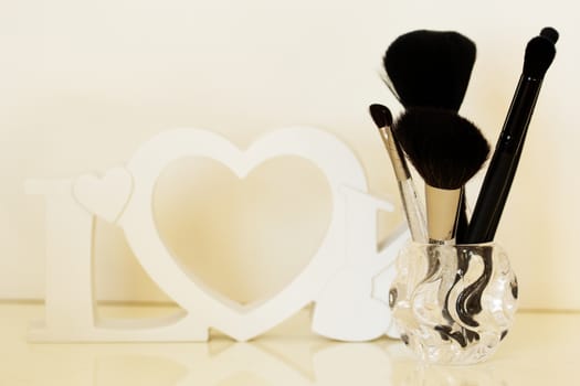 dressing table with makeup brushes on a  table, close-up