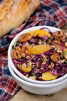 red coleslaw salad with slices of oranges and walnuts