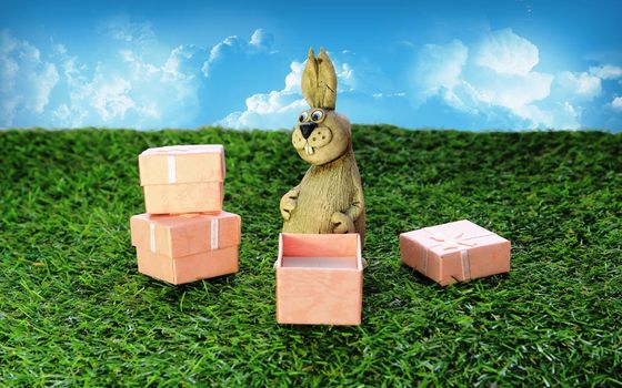 Easter. Brown Easter Bunny with pink gift box