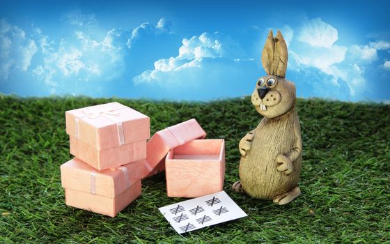 Easter. Brown Easter Bunny with pink gift box