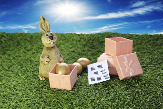 Easter. Brown Easter Bunny with pink gift box