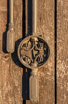 An electrical junction box on the side of a barn.