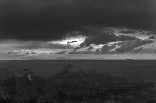 A black and white photo of a storm approaching over the Grand Canyon.