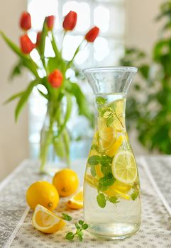 Fresh limes and lemonade on table