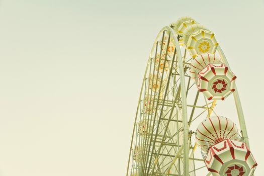 ferris wheel against a blue sky in vintage style