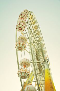 ferris wheel against a blue sky in vintage style
