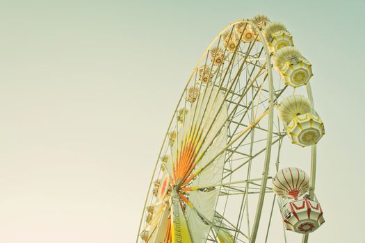 ferris wheel against a blue sky in vintage style