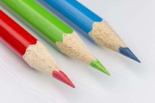 Red green and blue colored pencil as conceptual imagination for the primary RGB color encoding as used in the printing industry
