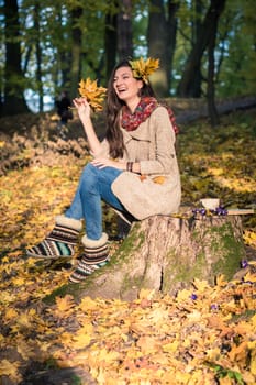 girl in autumn Park with leaves in the hands