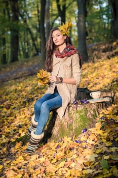 girl in autumn Park with leaves in the hands